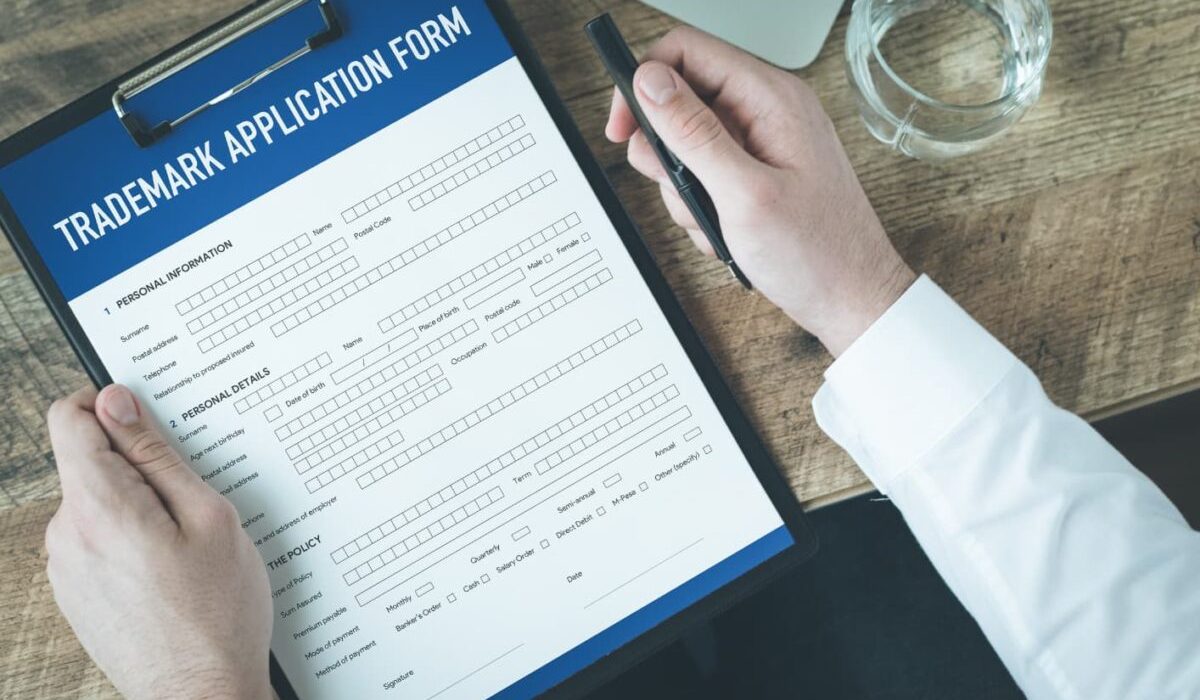 A man fills out an application for trademark registration in